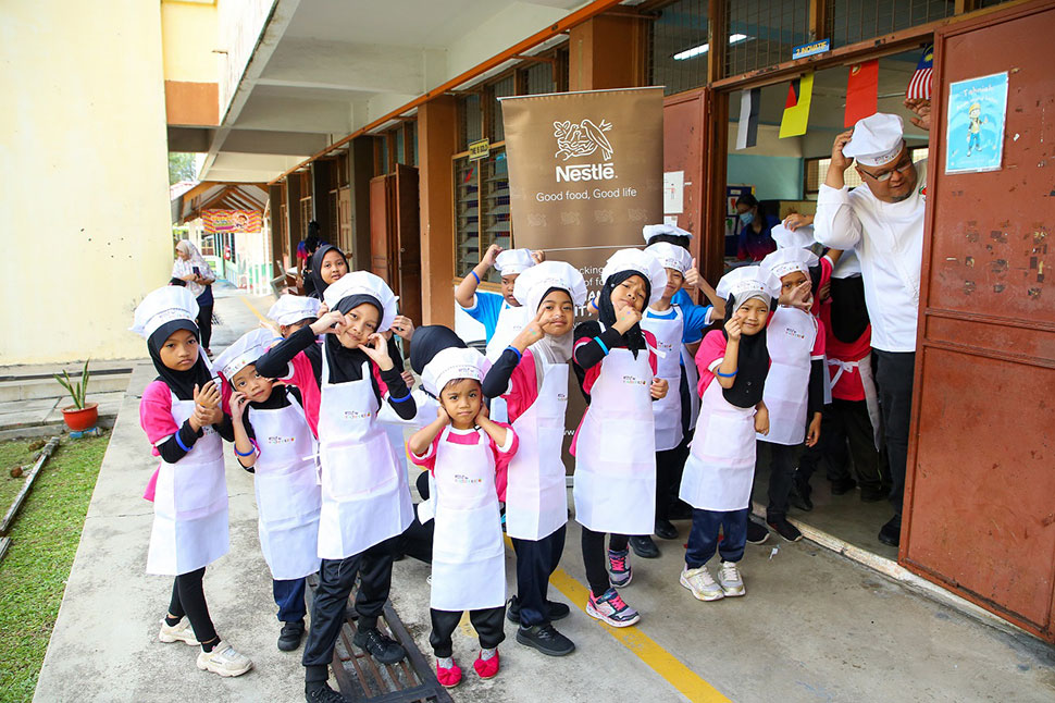 Young chefs at the N4HK PARENPRO proudly gear up to learn about healthy eating through interactive activities.