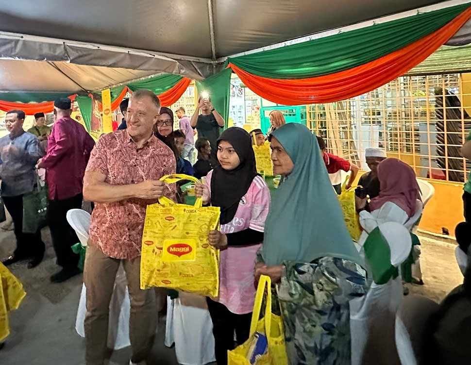Juan Aranols distributing MAGGI food packs containing essential groceries to villagers