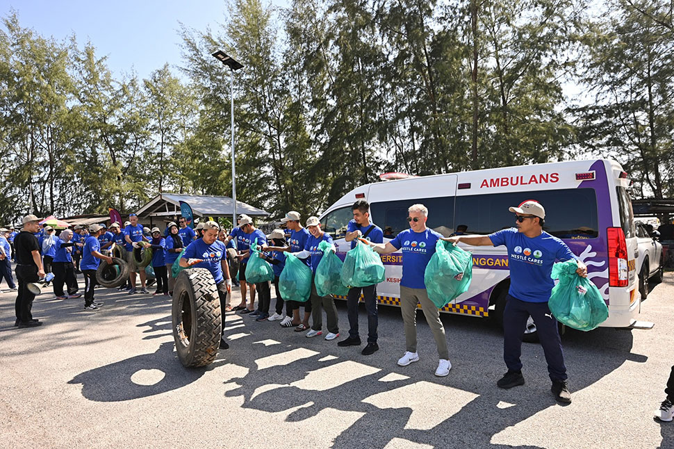 Volunteers form a line to channel collected marine waste