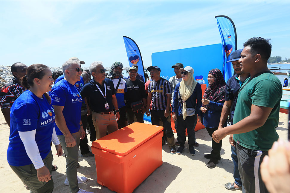 Mr. Juan Aranols, Chief Executive Officer of Nestlé Malaysia, presents essential fishing supplies and equipment to the local fishing community