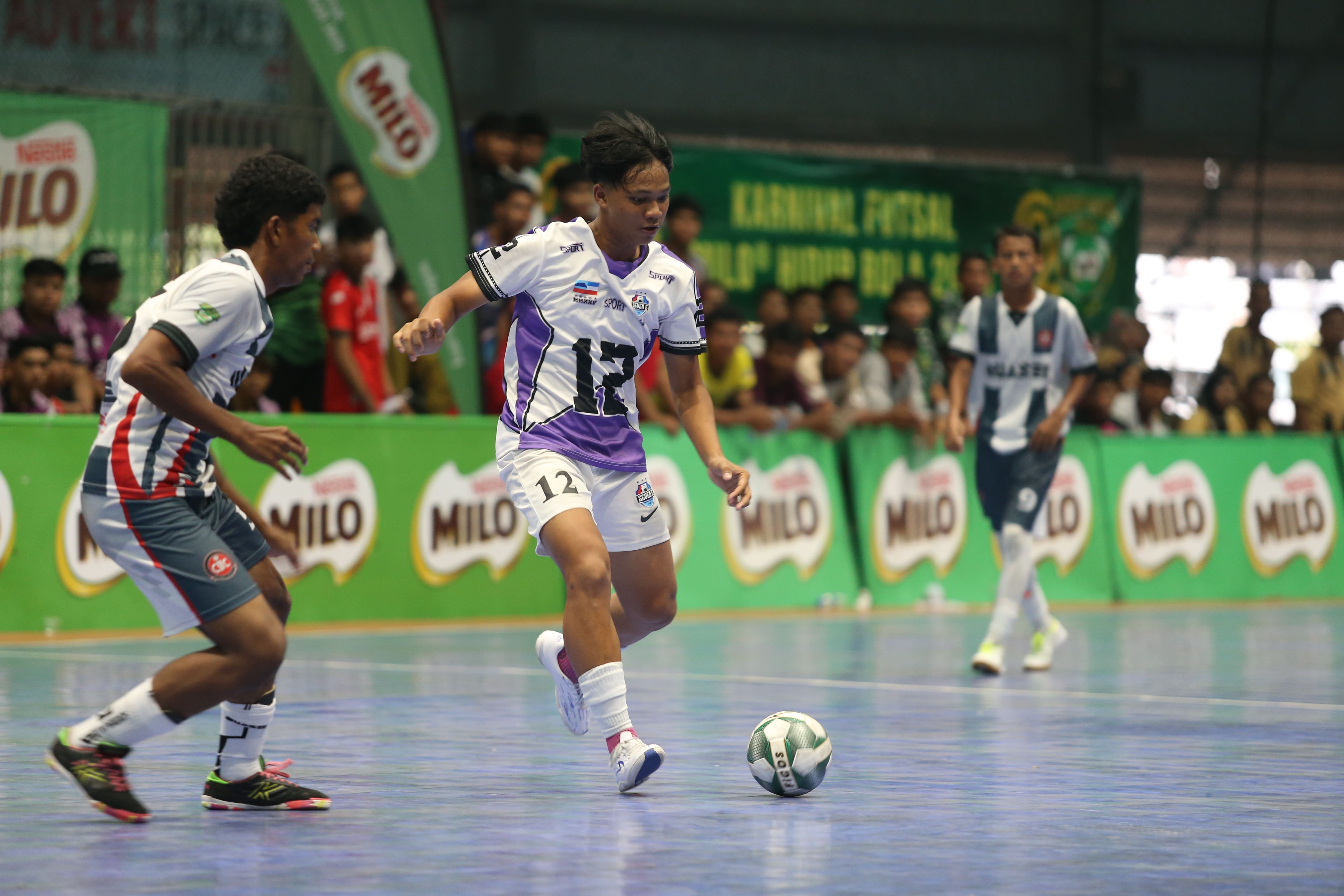 Seven E FC player (middle) keeping the ball in control