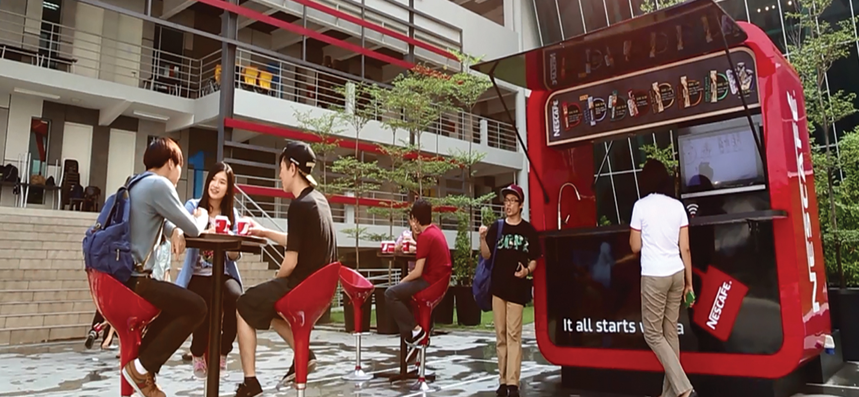 University students enjoying coffee at a Nescafé pop-up store on campus.